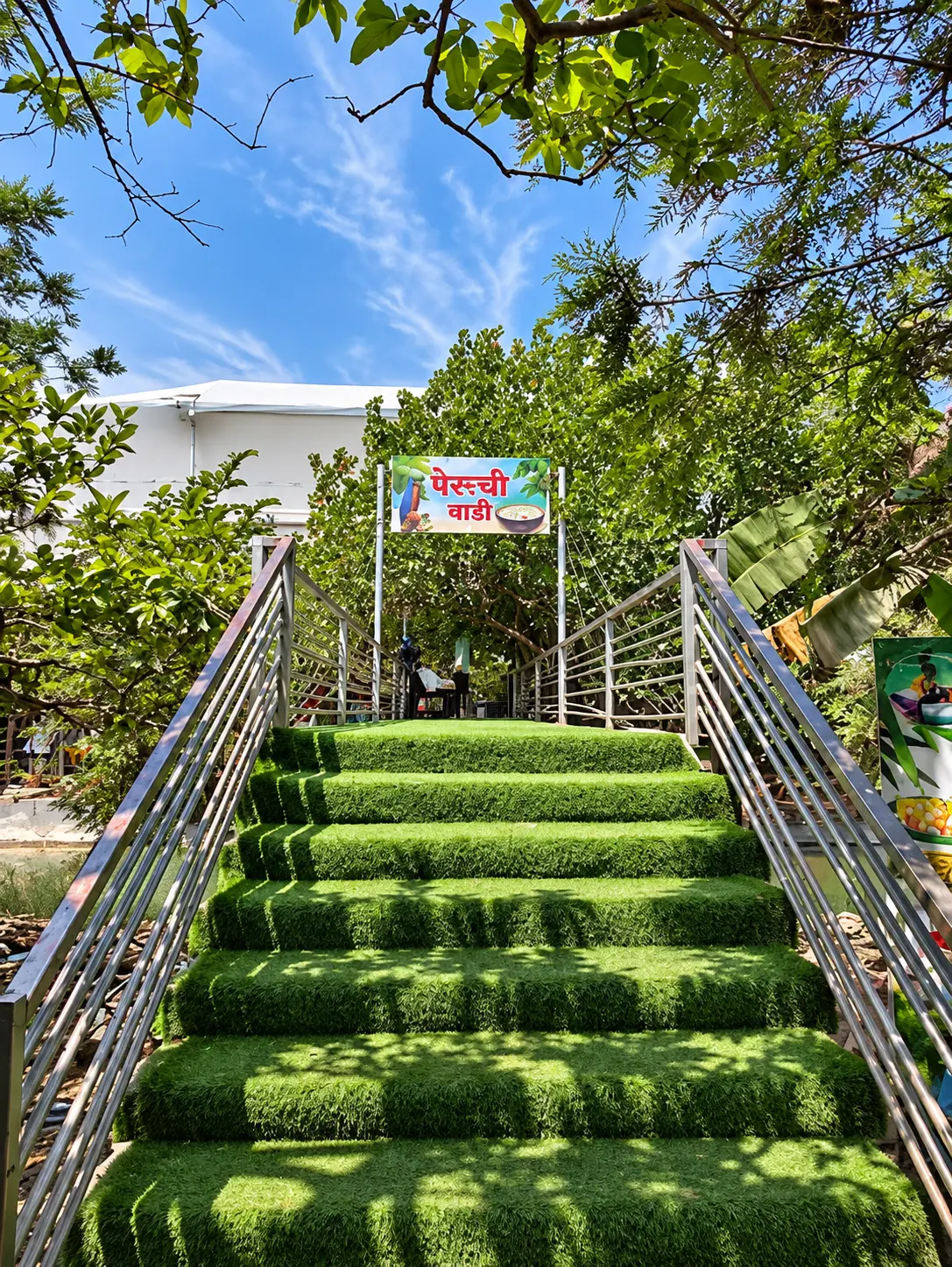 Turf-covered stairway leading to the Peruchi Wadi sign