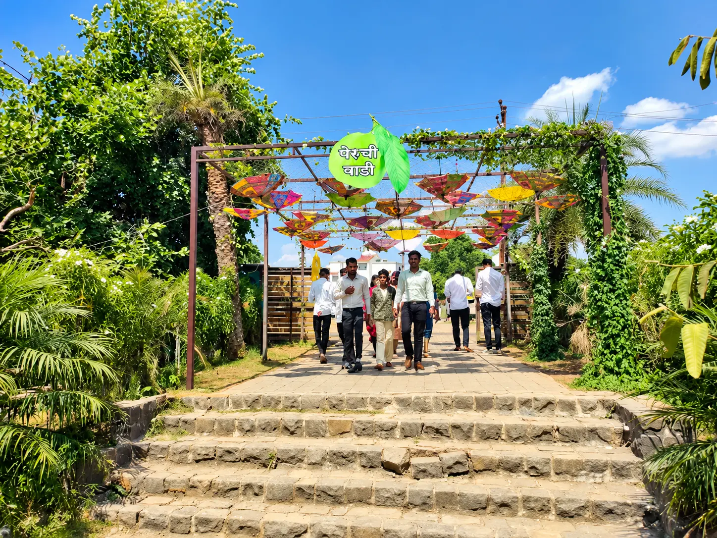Entrance arch with painted umbrellas and the Peruchi Wadi guava sign